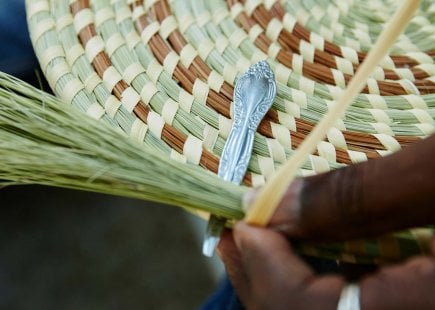 Man weaves a traditional Gullah basket