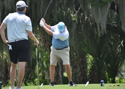 Two men playing golf