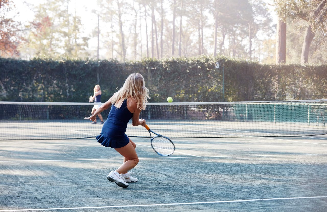 Two women play tennis