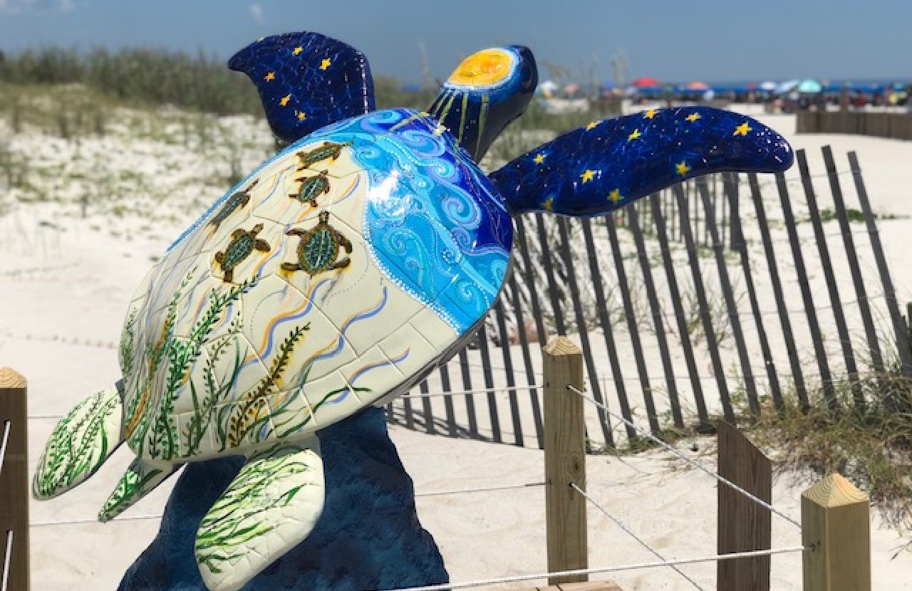 Painted turtle sculpture on the beach
