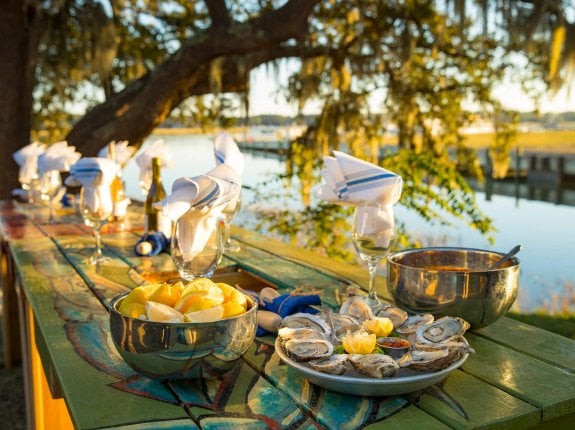 picnic table lined with fresh seafood and wine