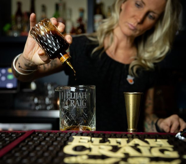 Monica pouring whiskey