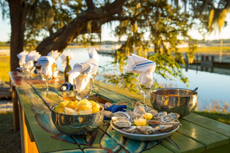 picnic table lined with fresh seafood and wine