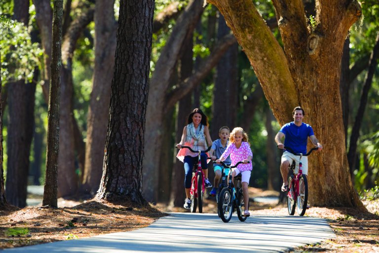 Family riding bikes on a trail