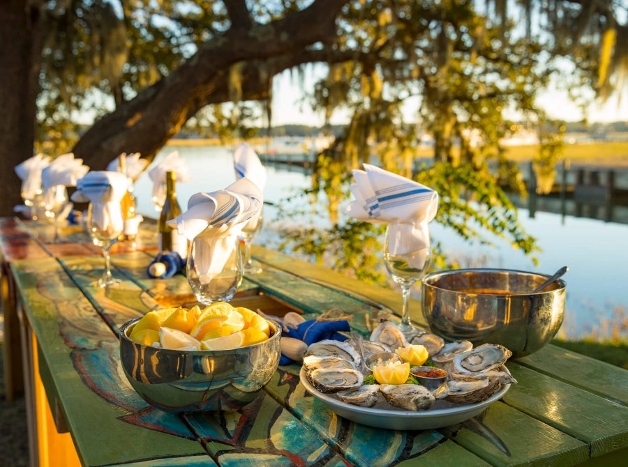 picnic table lined with fresh seafood and wine